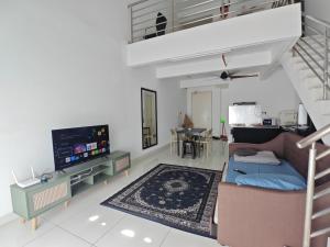 a living room with a couch and a tv at De Centrum Residences in Kajang