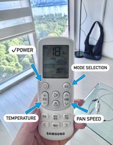 a person holding a cell phone in a room at Healing House in Seoul