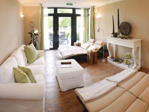 uma sala de estar com mobiliário branco e uma lareira em Rosendomizil em Malchow