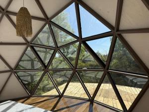 a glass ceiling in a room with a window at Domos munaQ Dusty in San Javier