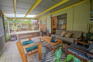 a living room with a couch and a table at Just Dandee in Naboomspruit