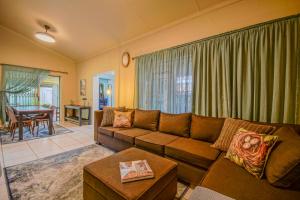 a living room with a couch and a table at Just Dandee in Naboomspruit