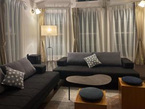 a living room with a couch and a table at インザ富士 in Fujiyoshida