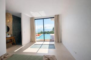 une chambre avec vue sur une piscine et une chambre à coucher dans l'établissement NAHA Villa Sea View Koh Phangan, à Baan Tai 7 autres photos