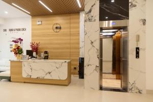 an office with a reception desk and marble walls at C&M Hotel in Phan Rang