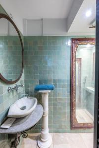 a bathroom with a sink and a mirror at Romantic Provence Pool & Mill View in Goult