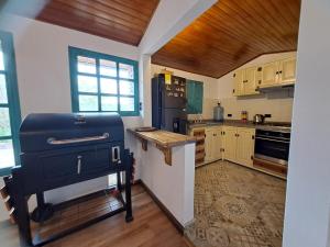 a kitchen with a black refrigerator and wooden cabinets at El Embeleso in Nobsa +9 photos