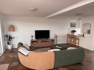 un soggiorno con divano e TV a schermo piatto di The Mooloolaba Terrace a Mooloolaba Altre 4 foto