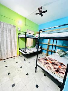 een kamer met 2 stapelbedden en een plafondventilator bij Hostel Desert Routes in Jaisalmer