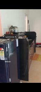 a kitchen with a stove and a refrigerator at Aarex 63B Sparsh Chalet in Dhamni