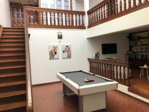 a room with a ping pong table and a staircase at Villa lagon bleu in Le Gosier