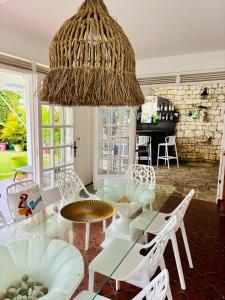 a dining room with a glass table and chairs at Villa lagon bleu in Le Gosier