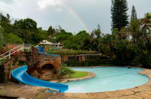 a water slide with a rainbow in the background at Condado de Casa Grande in San Gil
