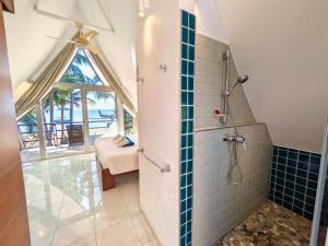 a bathroom with a shower with a glass window at Five Palms Beachfront Villa - by KohChangVillas in Ko Chang +39 photos