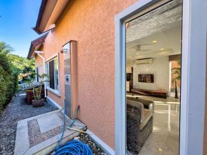 a glass door of a house with a yard at Five Palms Beachfront Villa - by KohChangVillas in Ko Chang