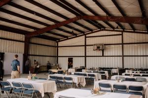 a man standing in a large room with tables and chairs at Zebra Ranch 16-guest Compound Mtn Vuspapkl Bal in Granite Dells