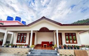 a house with a red chair in front of it at Rivero Resort in Dirang Dzong +9 photos