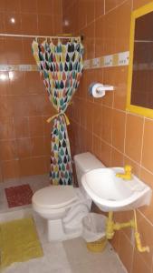 a bathroom with a toilet and a sink at Caribe Tolú in Tolú