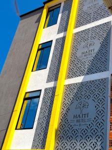 ein Gebäude mit einem gelben Streifen auf der Seite in der Unterkunft Haití Hotel B in Tumaco