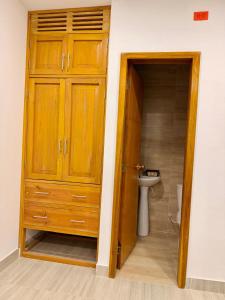 ein Badezimmer mit einem Holzschrank und einem Waschbecken in der Unterkunft Haití Hotel B in Tumaco