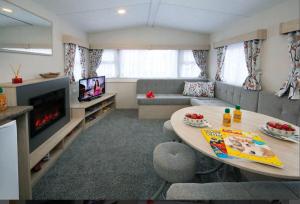 a living room with a table and a couch at Withamside Country Park in Boston