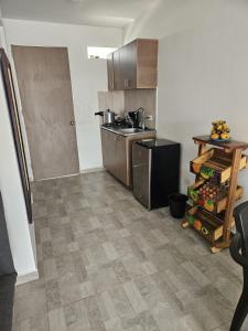 a kitchen with stainless steel appliances and wooden cabinets at Alpha1 in Roldanillo