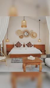 a bedroom with a bed and a coffee table at Crystal Bungalow DELUXE in Ko Phangan
