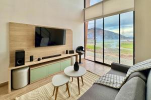 a living room with a couch and a tv at Tiny House con Jacuzzi, Fogata y Starlink in Anta