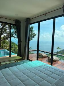a bedroom with a view of the ocean at Love koh tao villa 2 in Koh Tao