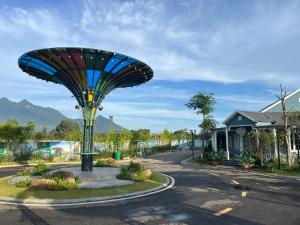 a street with a weird looking object in the middle of a road at Vườn vua resort- Sunvillas in Ðồng Phú