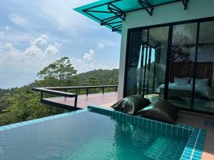 a villa with a swimming pool and a bedroom at Love koh tao villa 2 in Ko Tao