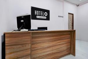 a reception desk with a hotel sign on a wall at Hotel O Ring Road Nagpur Formerly Glory Inn in Khāpri