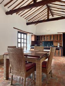 a kitchen with a wooden table and chairs at Cabaña VillaMaria in Villanueva