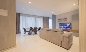 un soggiorno con un divano e un tavolo di Mercury Tower Apt 508 a San Giuliano