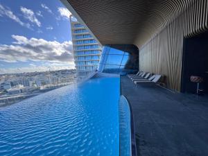 a swimming pool on the side of a building at Mercury Tower Apt 508 in St. Julianʼs