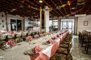 a long dining room with long tables and chairs at Hotel Tarconte in Tarquinia