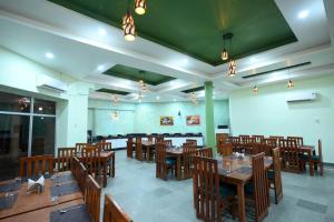 a dining room with wooden tables and chairs at The Van Bagh Ranthambore in Sawāi Mādhopur