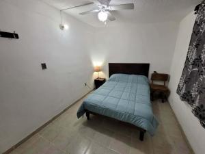 a bedroom with a bed and a ceiling fan at Liz in Matehuala