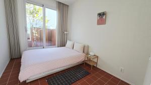 a small bed in a room with a window at 유유히 in Sowang-dong +42 photos