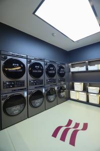 a row of washing machines in a laundry room at Crowne Plaza Foshan by IHG in Foshan