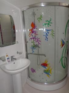 a bathroom with a shower with colorful fish on the wall at Jermuk Villa Imperial in Jermuk +51 photos