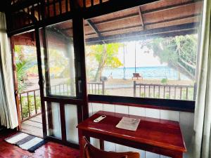 a table in a room with a view of the ocean at Bamboo Cottages in Phú Quốc