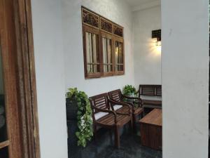 a room with two chairs and a table and a window at Stay Roside Villa Hikkaduwa in Hikkaduwa