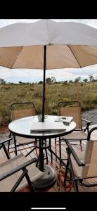a table and chairs with an umbrella over it at Atacama container in Brasília