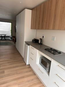 a kitchen with white cabinets and a counter top at Two Tides in Ballito +1 photo