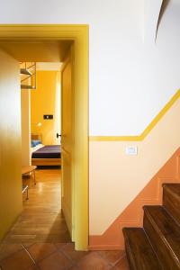a hallway with a staircase and a room with a bed at Casa Astarita in Sorrento