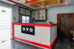 a red and white counter with an oo sign on it at Hotel O MK2 Hotel and Restaurant in Indore