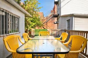 a table and chairs on a balcony with a table and chairs at FREE PARKING - In-Suite WASHER & DRYER - fully stocked KITCHEN - WORKSPACE PROVIDED - FAST WIFI - 5 minute walk to the most CENTRAL metro station IN MONTREAL - BERRI UQAM in Montréal