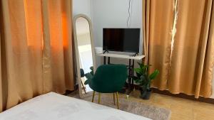 a bedroom with a desk with a computer and a mirror at Similan Mondo Resort & Camping in Phangnga