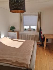 ein Schlafzimmer mit einem Bett, einem Schreibtisch und einem Tisch in der Unterkunft Das Litzldorf in Sankt Michael im Lungau